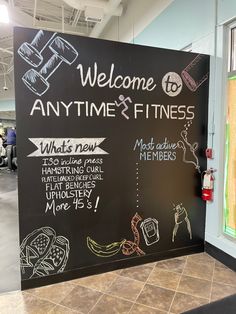 a blackboard sign that says, welcome to anytime and fitness what's new?