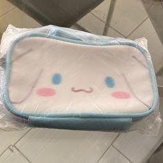 a close up of a bag on a table with a tile floor in the background