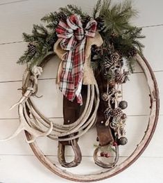 a wreath made out of horseshoes, rope and other items hangs on the wall