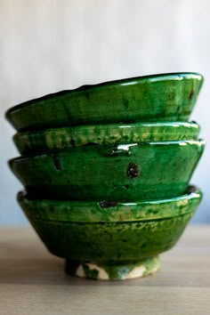 four green bowls stacked on top of each other