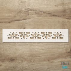 a wooden panel with flowers cut out of it