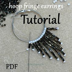 the hoop fringe earrings are made with black and white seed beads, which have been beaded together