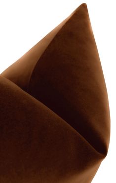 a close up view of a brown pillow on a white background with the fabric folded down