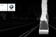 a black and white photo of a train track with the bmw logo in the background