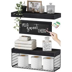 two shelves holding toilet paper, tissue and other household items on them with the words hello sweet cheeks written in chalk