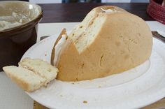 a white plate topped with a loaf of bread