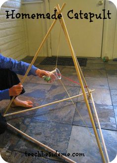 someone is making a homemade catapult out of sticks