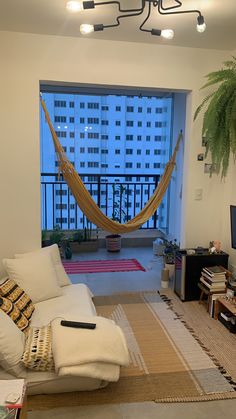 a living room filled with furniture and a hammock