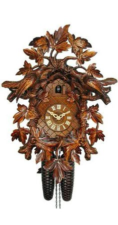 an ornate wooden cuckoo clock with leaves and acorns on the face is shown against a white background