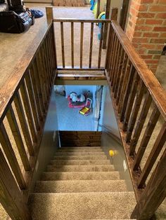 an open staircase leading up to a room with shoes on the floor and other items