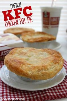 two pies sitting on top of a white plate next to boxes of biscuits and coffee