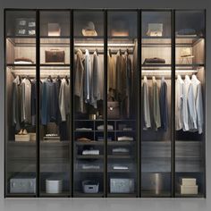 an open closet with clothes hanging on the walls and shelves in front of it,