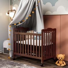 a baby crib with a teddy bear next to it