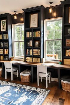 a room with several bookshelves and two chairs in front of the window, along with a rug on the floor