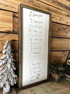 a christmas tree is next to a sign that reads i love you, i love you