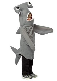 a young boy in a shark costume