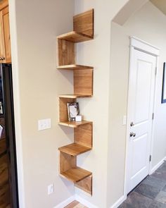 the corner shelves are made out of wood and have been placed on the wall for storage