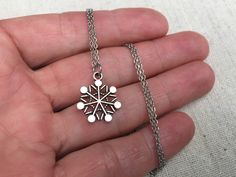 "This is such a sweet and stylish silver snowflake pendant necklace. It is the perfect everyday size, wear it all winter long! It would make the perfect gift for any snow and winter loving person. Pray for snow! The snowflake measures 5/8\" long by 1/2\" wide and hangs from a simple 18\" stainless steel necklace chain with a lobster clasp. I have matching earrings in my shop, if you would like the whole set! Here is the link https://etsy.me/2AwKBzN Thanks for stopping by! Please take a moment an Winter Snowflake Necklace, Silver Necklaces For Winter Holidays, Winter Snowflake Necklace, Perfect For Gifts, Necklace Snowflake, Acorn Jewelry, Green Tassel Earrings, Snowflake Jewelry, Snowflake Necklace, Silver Statement Earrings