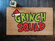 a door mat with the words grinch squad on it