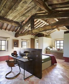 a bed room with a neatly made bed and a desk