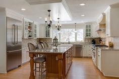 a large kitchen with an island in the middle