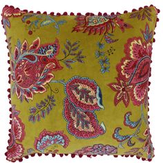 a yellow pillow with red and blue flowers on it