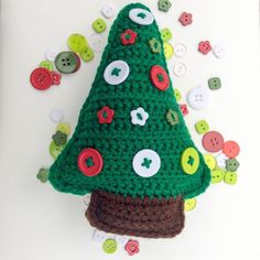 a crocheted christmas tree with buttons on it