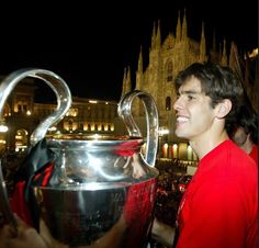 a man in red shirt holding up a trophy