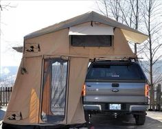 a truck is parked next to a tent