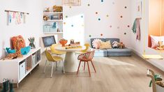 a child's playroom with colorful polka dot wallpaper and wooden flooring