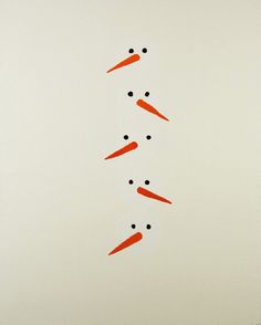 carrots are arranged in the shape of an x on a white background with black dots