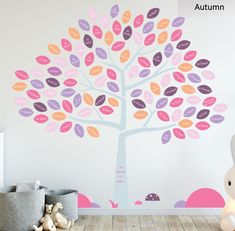 a child's room with a large tree painted on the wall