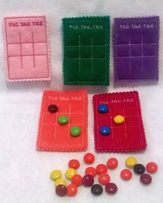 four different colored candy candies and one is in the shape of a tic - tac - toe