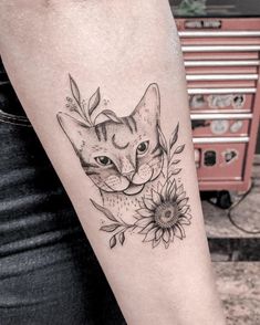 a cat with sunflowers and leaves on it's arm is shown in black ink