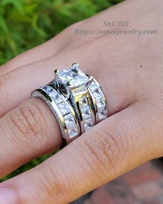 a woman's hand with two rings on top of her finger and the ring is made out of gold and white diamonds