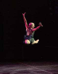 a woman is jumping in the air on a trampoline