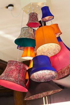 a chandelier with many different colored lamps hanging from it