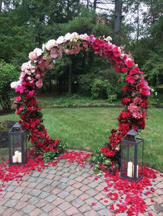 an arch made out of flowers and candles