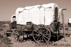 an old covered wagon in the middle of nowhere