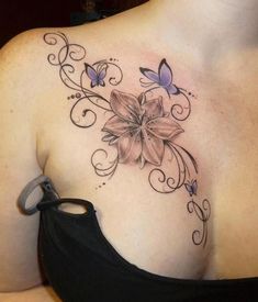 a woman's chest with flowers and butterflies on it