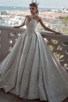 a woman in a ball gown standing on a balcony