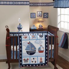 a baby crib bedding set with sailboats on it