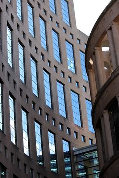 two tall buildings next to each other with windows