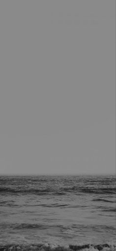 a man riding a surfboard on top of a wave in the ocean