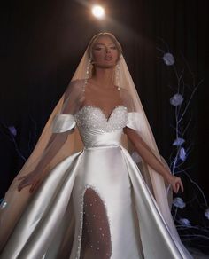 a woman in a white wedding gown and veil