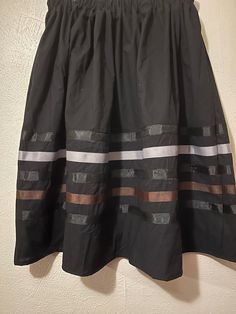 Ribbon skirt - black brown print Ribbon Skirt - Authentic Native American design for Pow Wow and Native American dances.  Skirt has an elastic waist that gives it the elusion of an A-line skirt.  Most skirts are 100% cotton or primarily cotton.  PLEASE CHOOSE YOUR SIZE BELOW!!  Ribbon Skirt is meant to be a mid-calf-length skirt and is typically 31 - 32 inches. Skirt length may be adjusted, if it needs to be longer please choose the the long skirt option, not all skirts can be ordered 'long'. Sk Black Voluminous Mini Skirt, Black Gathered Mini Skirt, Black Voluminous Flared Skirt, Casual Black Voluminous Skirt, Voluminous Black Flared Skirt, Black Full Skirt With Gathered Detail, Black Pleated Full Skirt, Black Voluminous Skirt With Lining, Black Voluminous Gathered Skirt