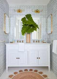 a bathroom with a large plant in the middle of it and two mirrors on the wall