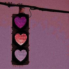 a traffic light with three hearts on it