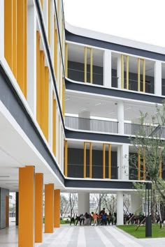 an apartment building with yellow and white balconies