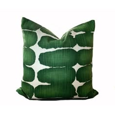 a green and white pillow sitting on top of a table